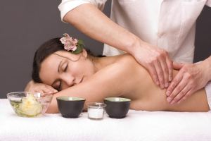 masseur gettins massage beautiful young woman